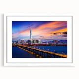 Abstract art print of Seoul skyline in muted gray and blue tones, framed with a white mat, ideal for dining room decor.