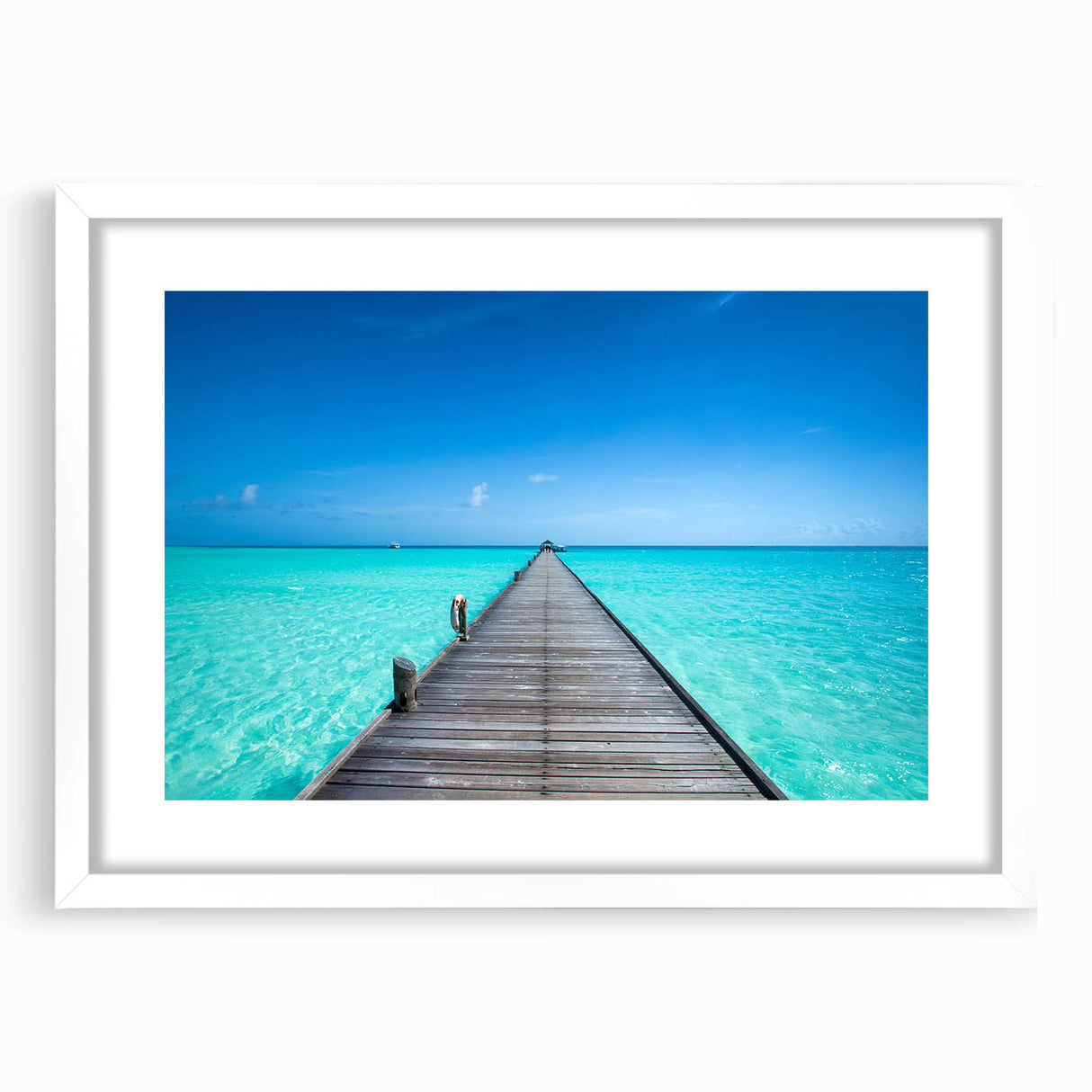Abstract art print of Maldives scenery in muted blue and green tones, framed with a white mat.
