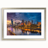 Abstract art print of Melbourne scenery in muted blue and gray tones, framed in silver, suitable for dining room decor.
