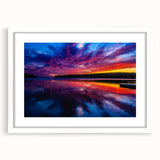 Abstract art print depicting a serene Manitoba landscape in cool blues and greens, framed in white.