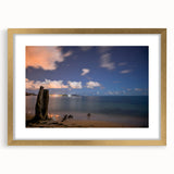 Abstract art print of a Caribbean scenery in muted blue and green tones on a framed canvas, suitable for dining room decor.