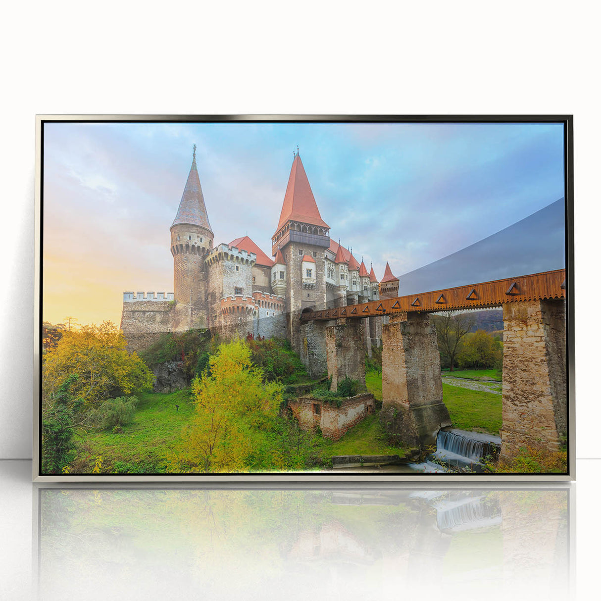 Large art print of a Romanian landscape in muted green and blue tones, framed in silver acrylic.