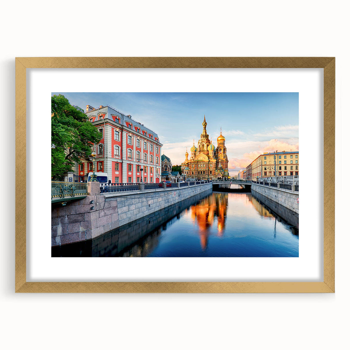 Abstract art print of a European cityscape in muted gray and gold tones on a framed canvas.