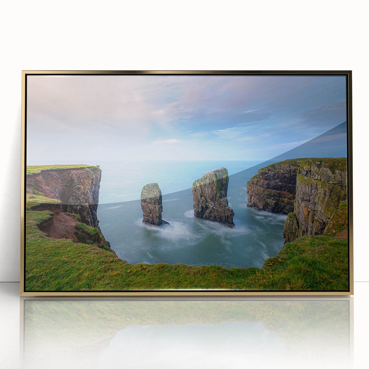 Large acrylic print of a serene Welsh landscape in soft green and blue tones, framed in gold.