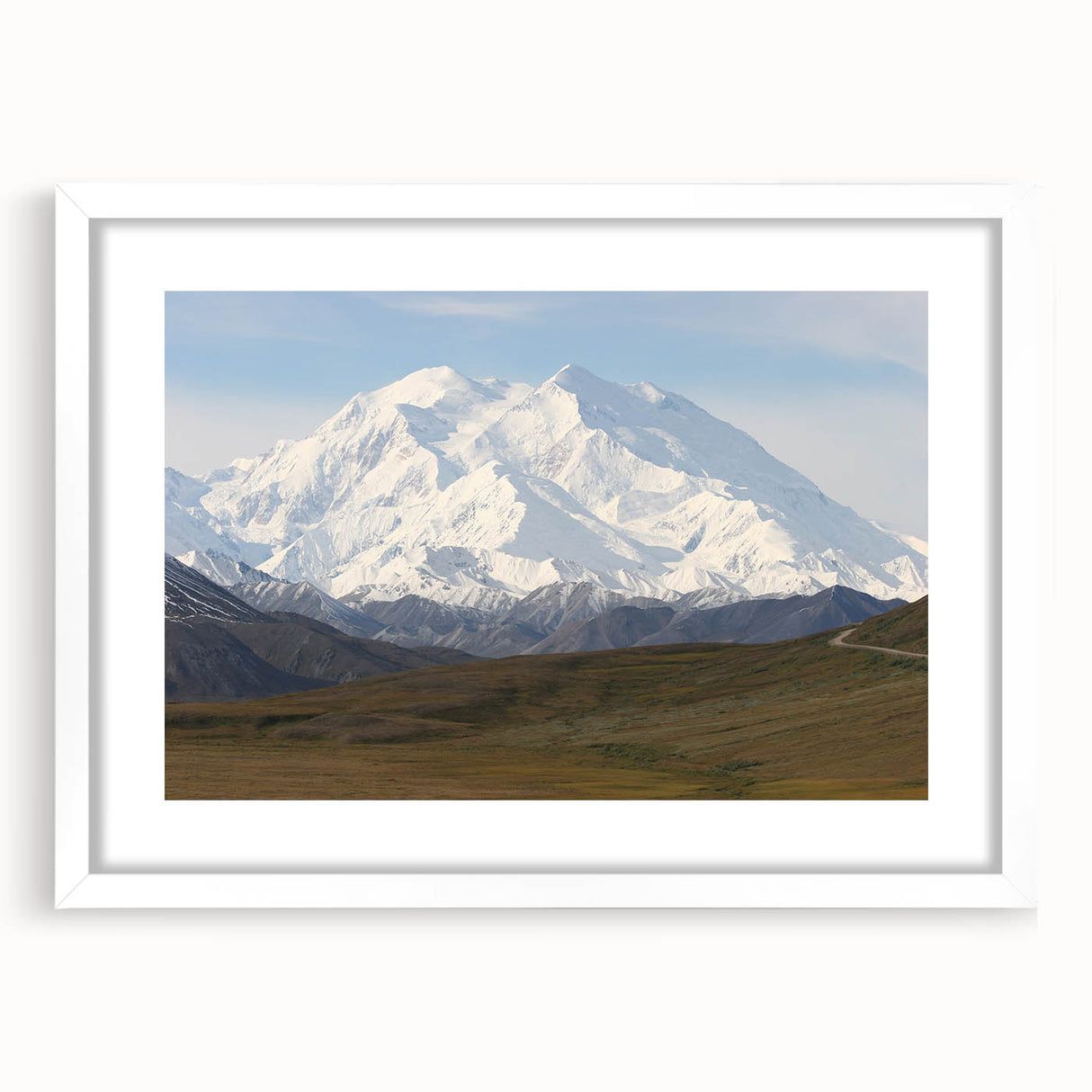 Abstract art print depicting Denali, Alaska in muted earth tones on a framed white mat, suitable for dining room decor.