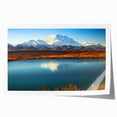 Alaskan landscape with floral elements in soft blue and green tones on a rolled canvas.