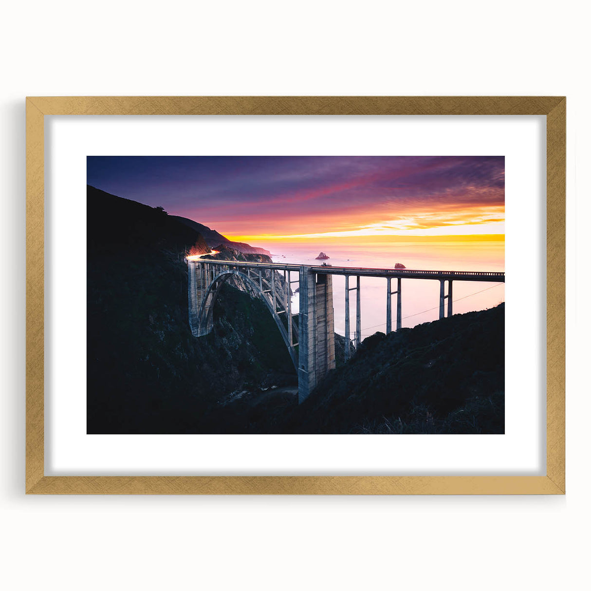 Extra large abstract art print of Big Sur, featuring textured blues and grays, framed in gold, ideal for living room decor.