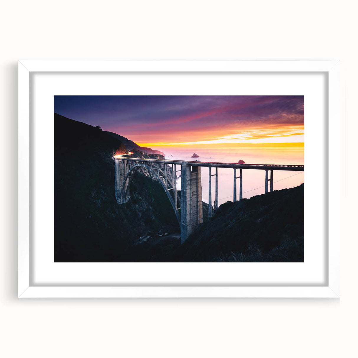 Abstract art print of Big Sur in muted blue and green tones on a framed white mat, ideal for dining room decor.