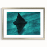 Textured art print of abstract ocean waves in blue and white, framed in silver, ideal for bedroom art.