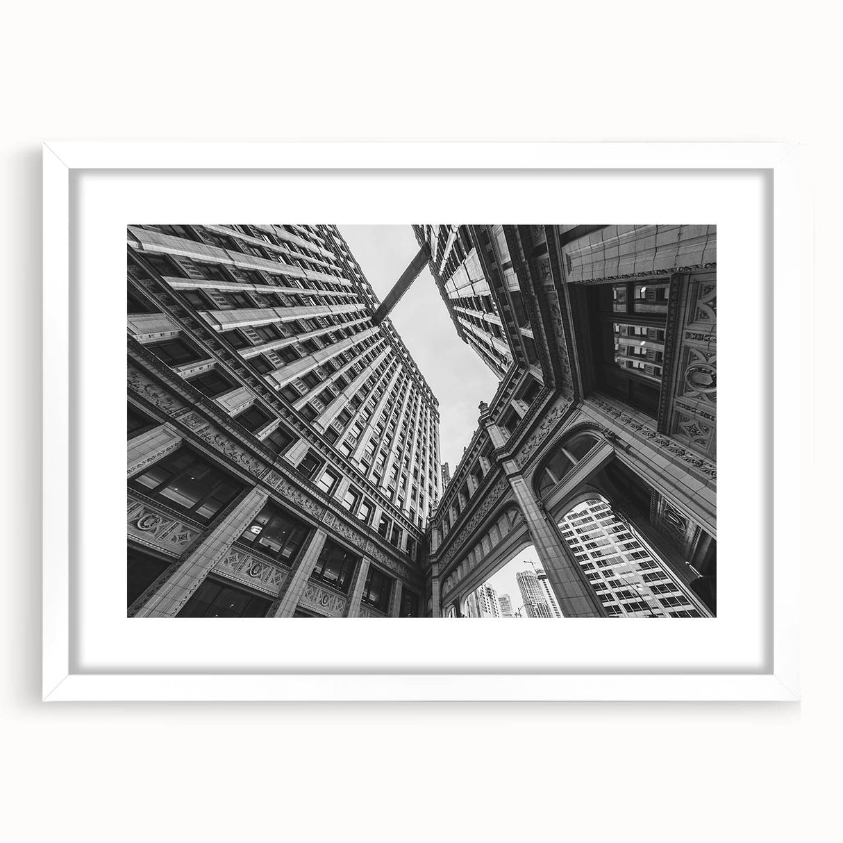 Abstract art print of Chicago skyline in muted gray and blue tones on a framed white mat, ideal for dining room decor.