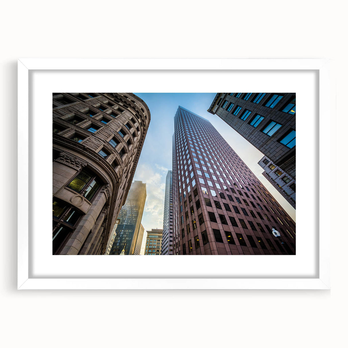 Abstract art print of Boston skyline in muted blue and gray tones on a framed white mat.