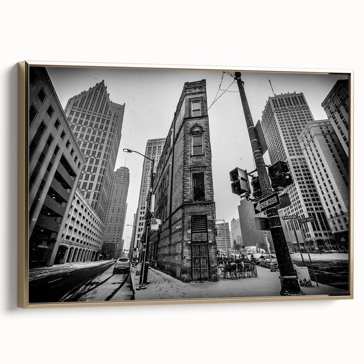 Framed canvas wall art featuring a vintage-style landscape painting of Detroit, Michigan, in muted gold and black tones.