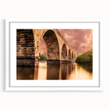 Abstract art print of Minneapolis skyline in muted blue and gray tones on a framed white mat, ideal for dining room decor.