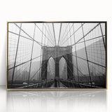 Acrylic print of the Brooklyn Bridge in muted gray tones, framed in gold, ideal for modern art wall decor.