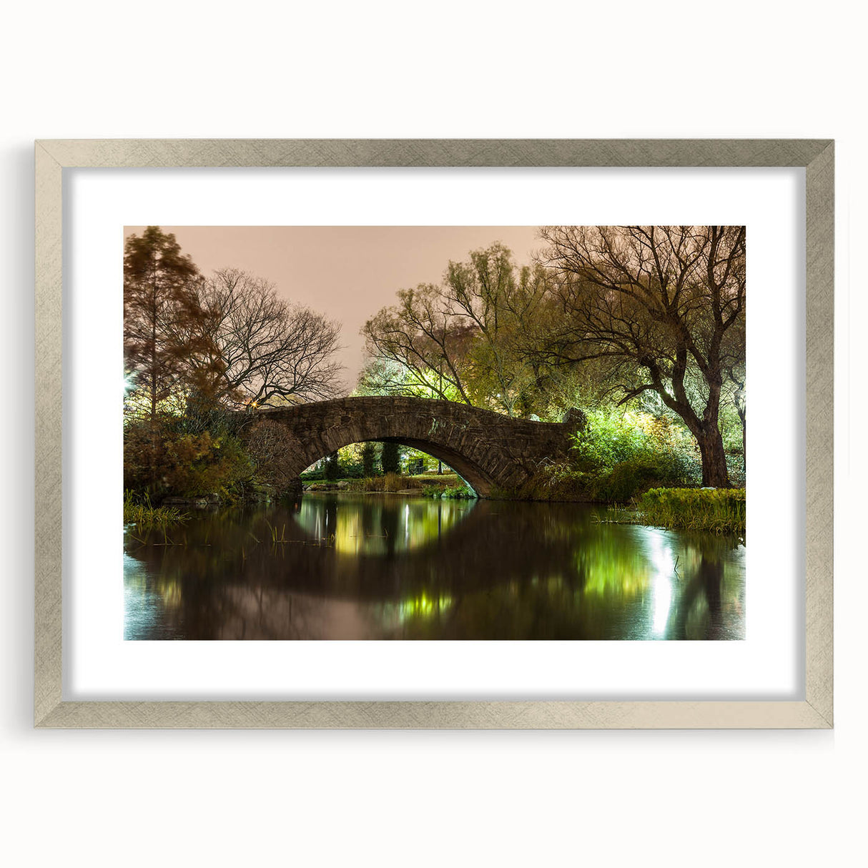Textured art print of Central Park with abstract design in muted green and brown tones on a framed silver mat.