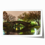 Rolled print of Central Park with lush greenery and a skyline backdrop, in muted green and blue tones.