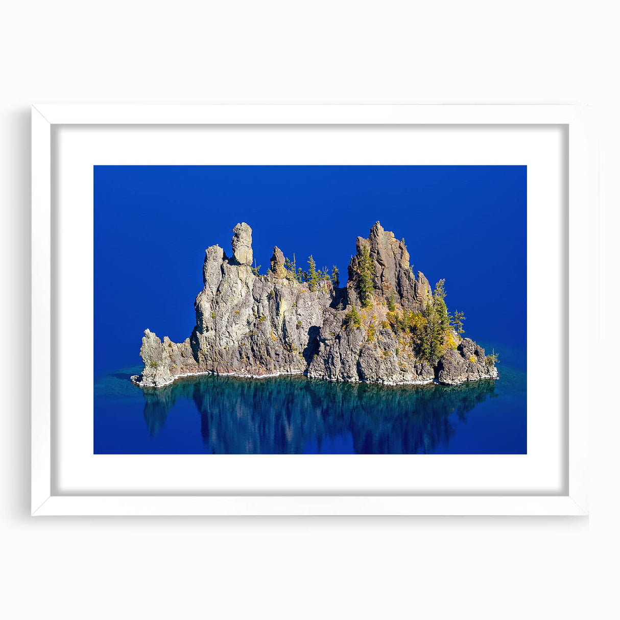 Abstract art print of Crater Lake with vibrant blue and green tones on a white framed canvas.