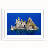 Abstract art print of Crater Lake with vibrant blue and green tones on a white framed canvas.
