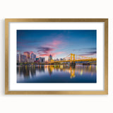 Extra large abstract art print of Pittsburgh skyline in gold frame, featuring textured brush strokes in muted earth tones.