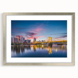 Textured art depicting abstract Pittsburgh skyline in muted grays and blues on a framed silver mat.