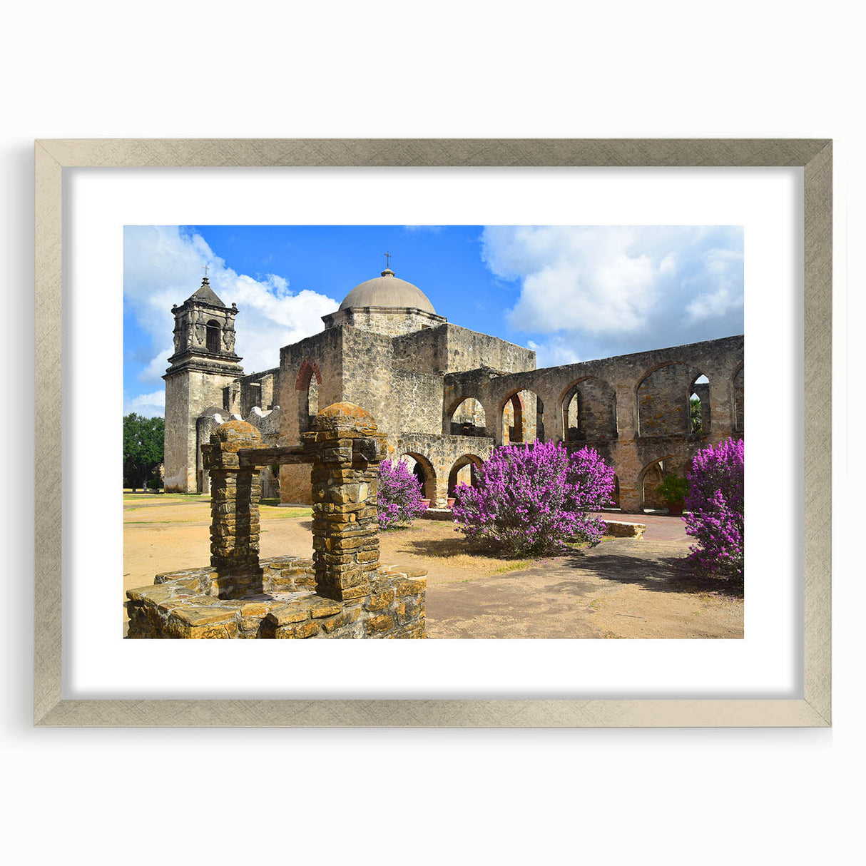 Textured art depicting abstract San Antonio scenery in muted earth tones on a framed silver mat, ideal for bedroom decor.