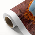 Art deco style poster of Arches National Park in Utah, featuring earthy red and orange tones on rolled canvas.