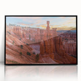 Large abstract wall art depicting Bryce Canyon in muted orange and red tones, framed in black acrylic.