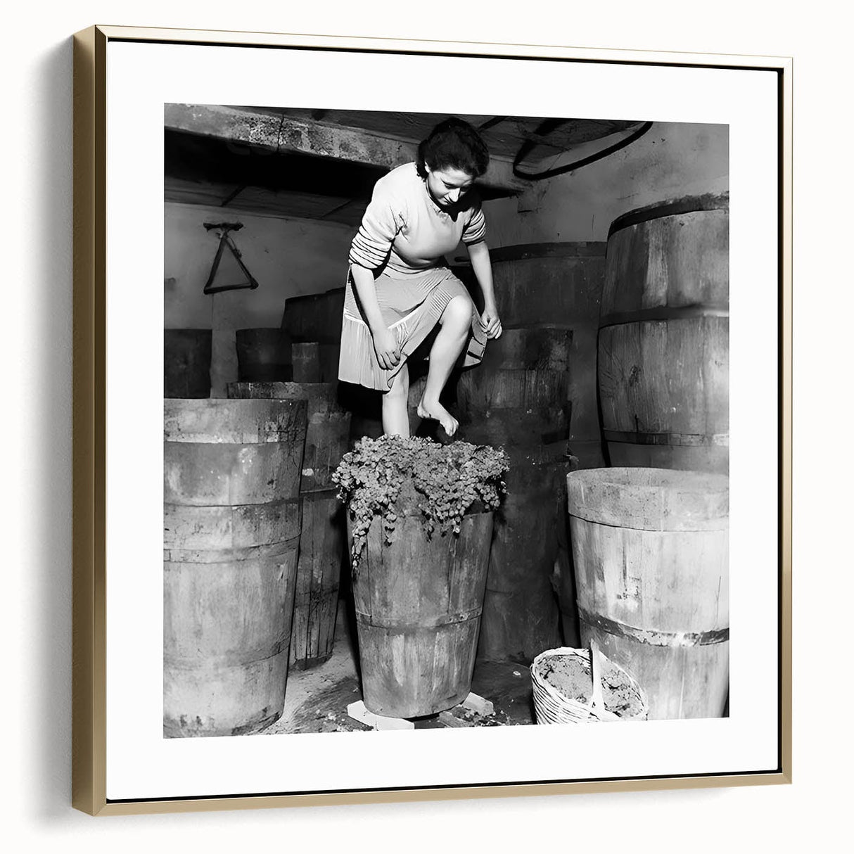 Framed canvas wall art featuring a vintage poster design of a landscape scene in muted gold and silver tones.