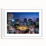 Abstract art print of Seoul skyline in muted blue and gray, framed in white, ideal for dining room decor.