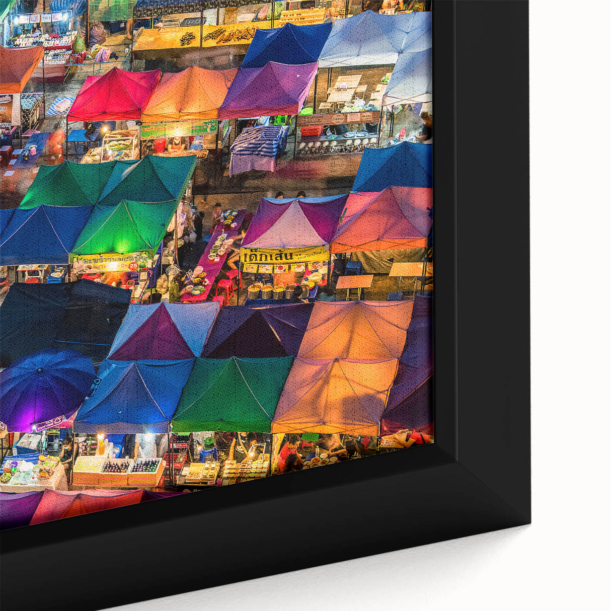 Close-up of black wall art featuring a textured Bangkok cityscape in vibrant colors on a framed canvas.
