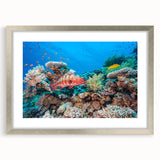 Abstract art print of the Great Barrier Reef in blue and green tones on a framed canvas, suitable for dining room decor.