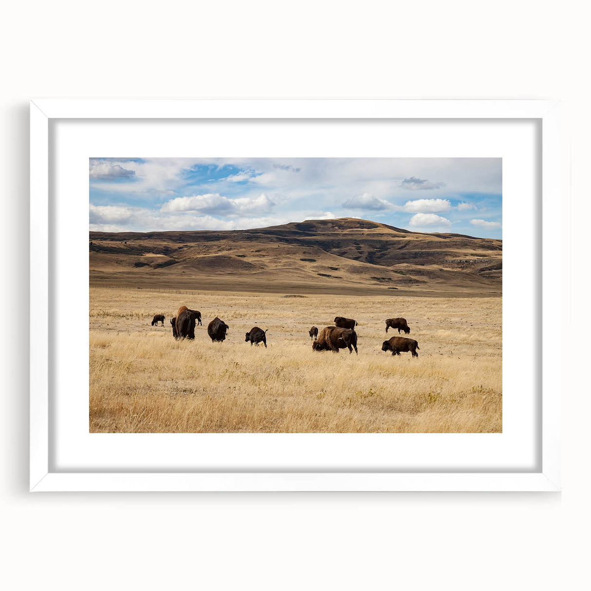 Abstract art print of Alberta scenery in muted earth tones, framed with a white mat, ideal for dining room decor.
