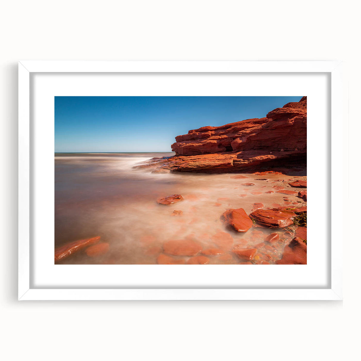 Abstract art print featuring a serene Prince Edward Island landscape in muted green and blue tones, framed with a white mat.