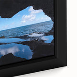 Close-up of large black wall art featuring a vibrant, textured Caribbean scenery on framed canvas.