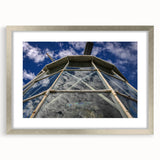 Abstract art print of Caribbean scenery in muted blue and green tones, framed in silver, ideal for dining room decor.