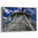 Framed canvas featuring a vintage-style Caribbean landscape with vibrant blue and green tones.