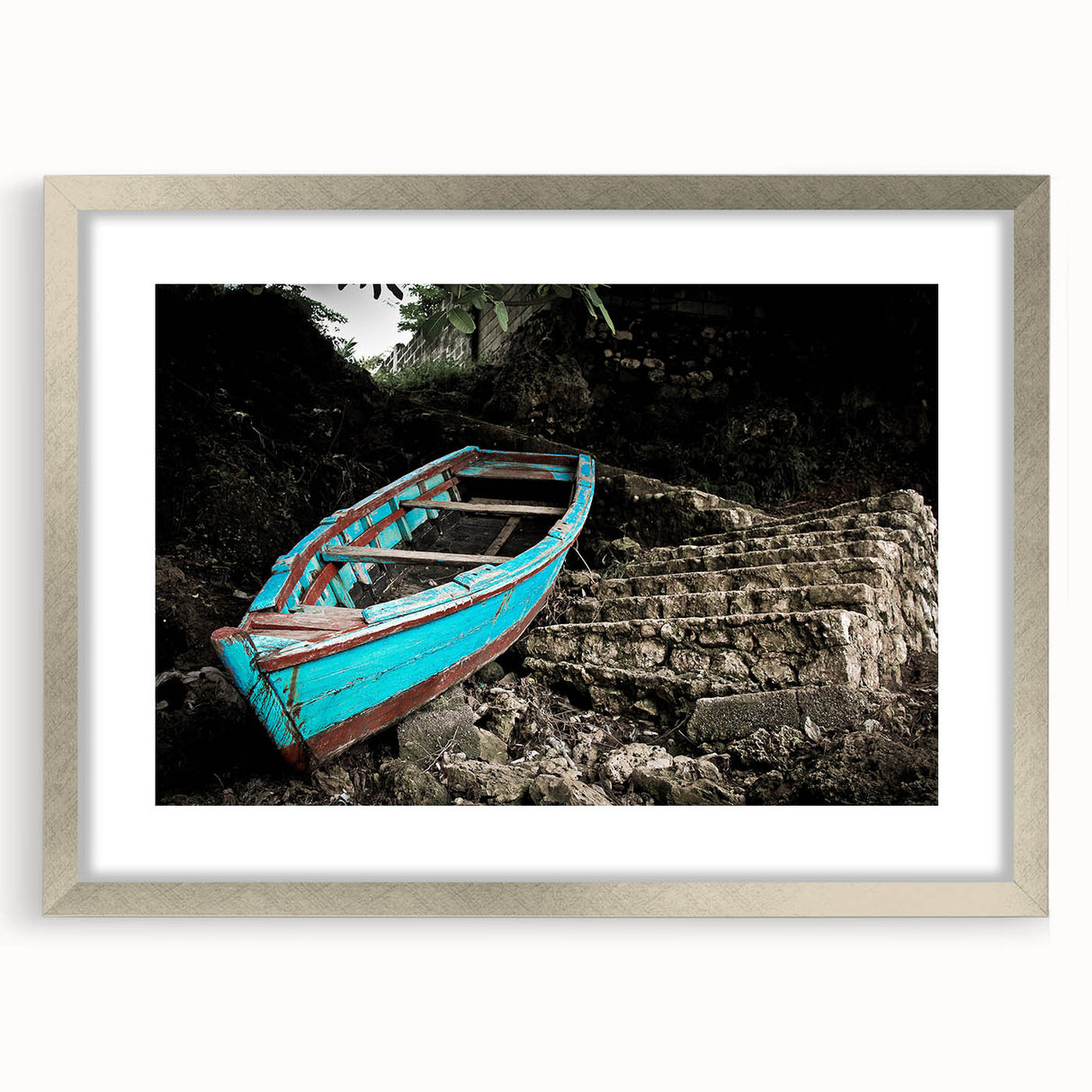 Abstract art print depicting Caribbean scenery in vibrant blue and green hues, framed in silver.