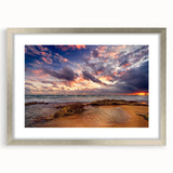 Abstract art print featuring Caribbean scenery in muted blue and green tones, framed in silver.