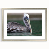 Extra large wall art depicting an abstract Caribbean scene in vibrant blues and greens, framed with a silver mat.