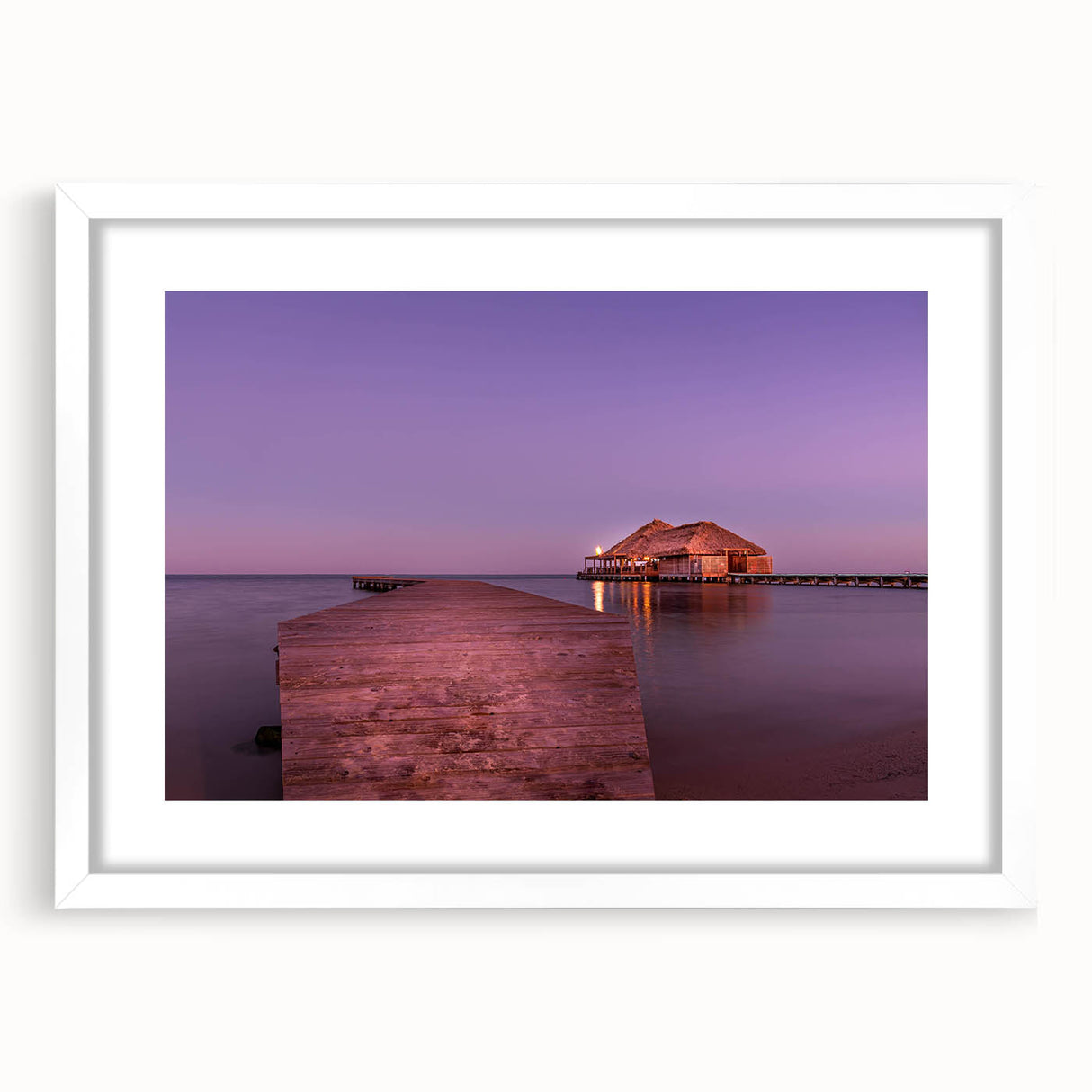 Abstract art print of a Central American scenery in muted earth tones, framed with a white mat.