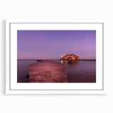 Abstract art print of a Central American scenery in muted earth tones, framed with a white mat.