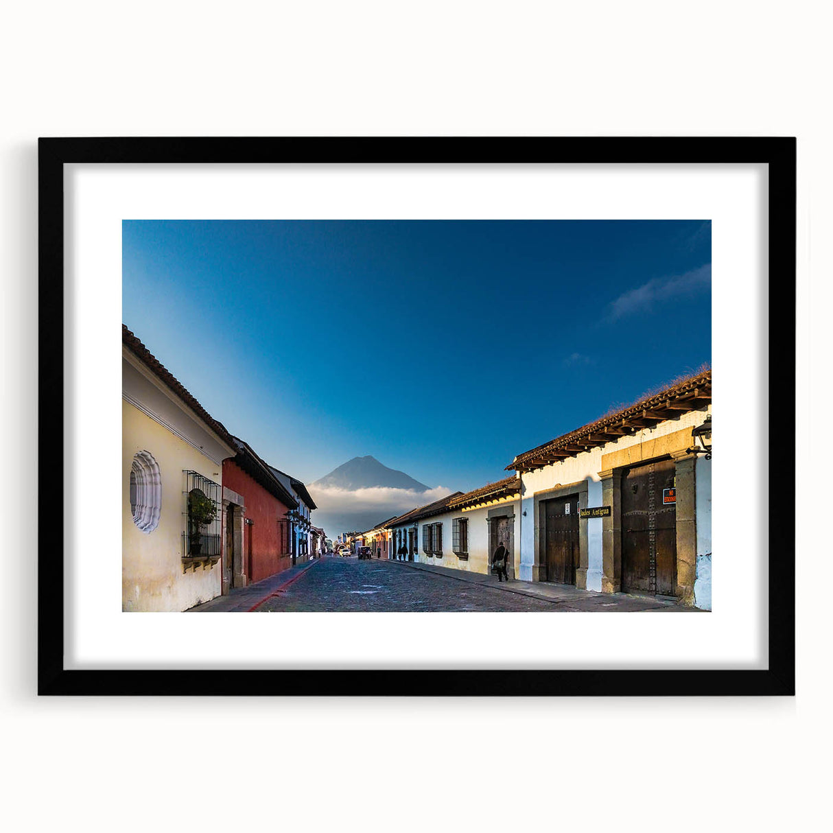 Abstract art print of a vibrant, colorful Central American scenery on a large textured canvas, framed in black.