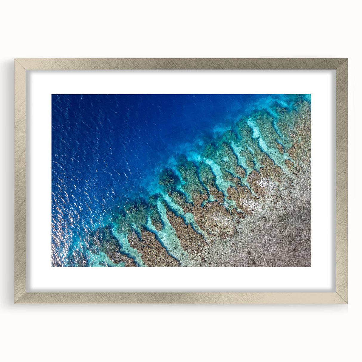 Textured abstract art print depicting a soft, muted color palette of blues and grays, presented in a silver frame.