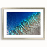 Textured abstract art print depicting a soft, muted color palette of blues and grays, presented in a silver frame.