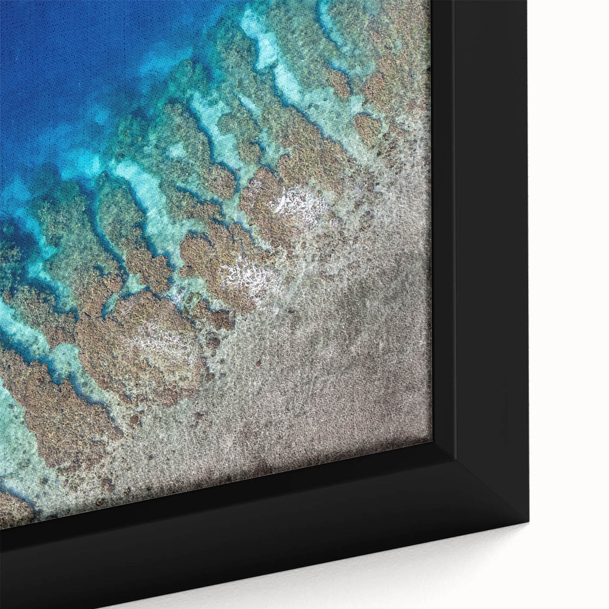 Close-up of textured black wall art featuring a vibrant, colorful Central American scenery on a framed canvas.