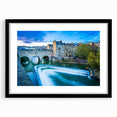 Abstract art print of colorful, textured scenery, framed in black, ideal for living room decor.