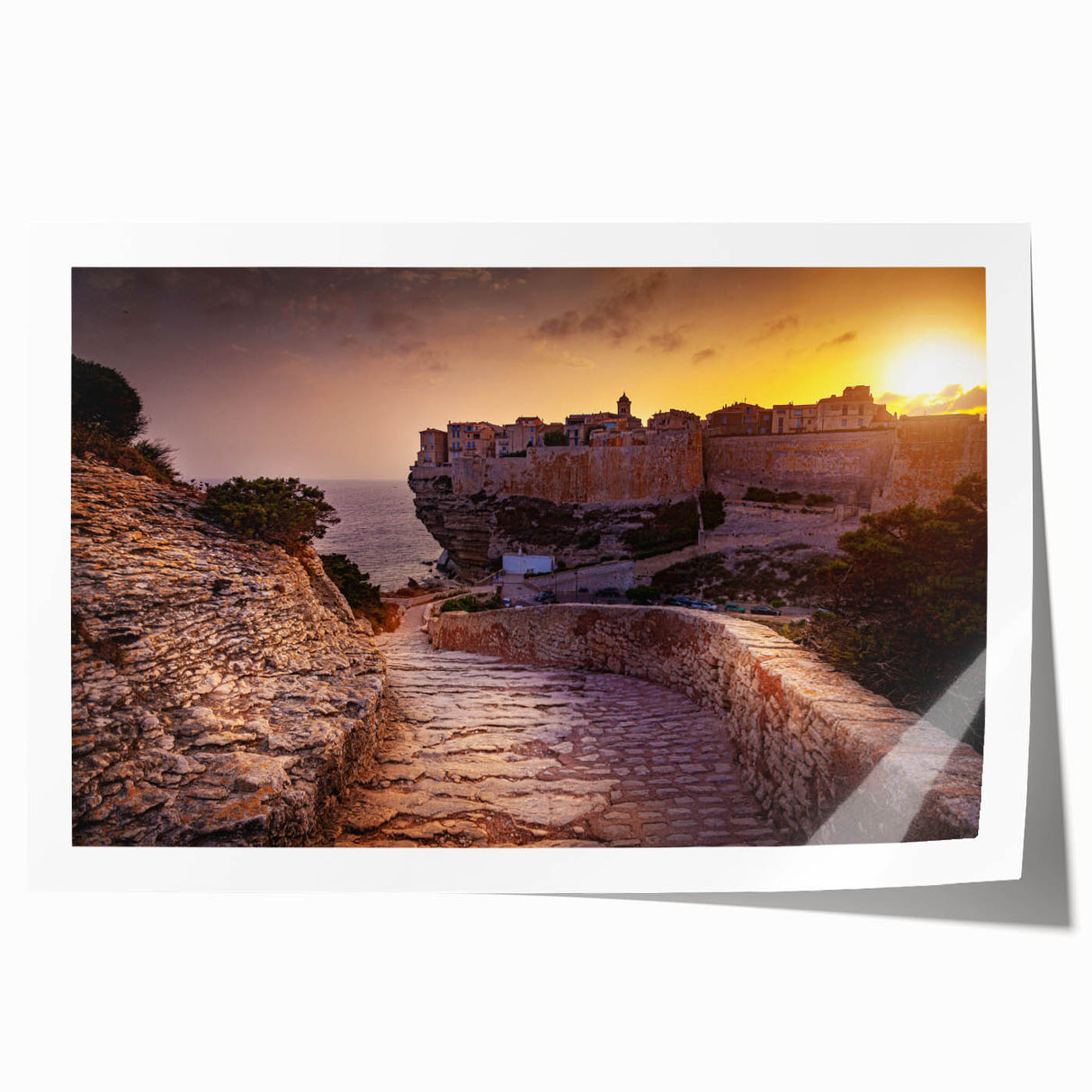 Rolled print of a Corsican landscape featuring lush greenery and distant hills, in muted earth tones.