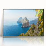 Large art print of a Capri, Italy landscape in muted blue and green tones on a silver-framed acrylic.