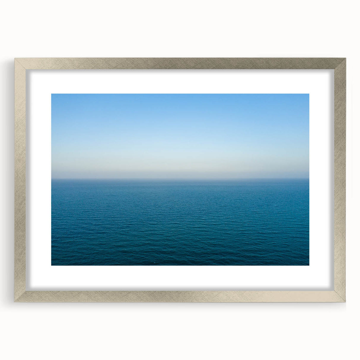 Extra large abstract art print depicting the Mediterranean Sea in textured blues and greens, framed in silver.