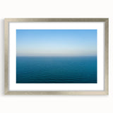 Extra large abstract art print depicting the Mediterranean Sea in textured blues and greens, framed in silver.